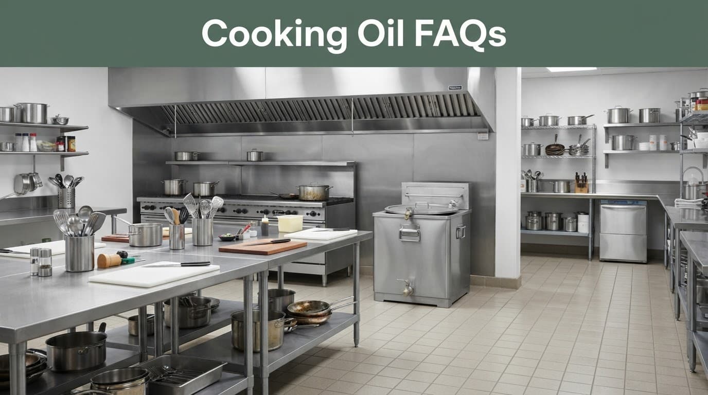 Clean commercial kitchen with stainless steel tables and a metal oil collection container.